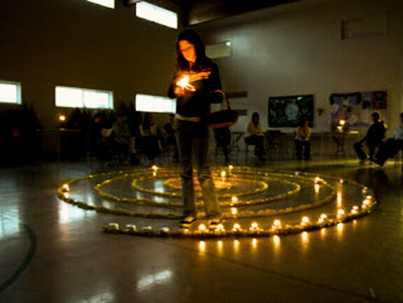 Participant walking the candlelit cosmic labyrinth